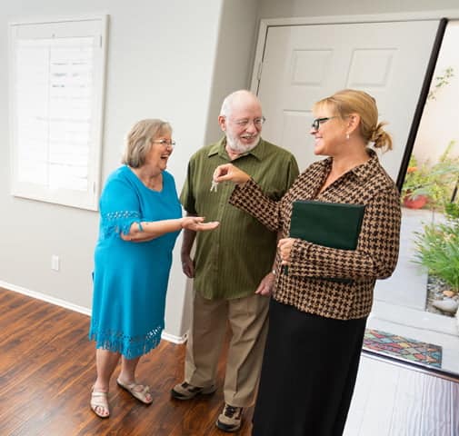 Elderly Couple accepting keys to an apartment